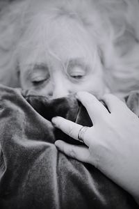 High angle view of senior woman covering face with fabric