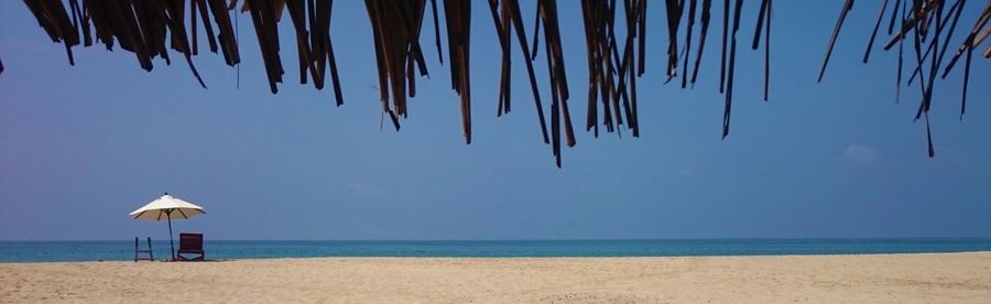 Scenic view of beach against blue sky