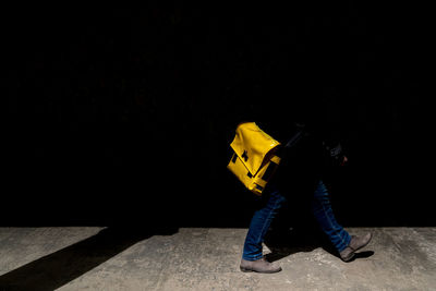 Low section of man walking on footpath