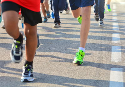 Low section of women running on street