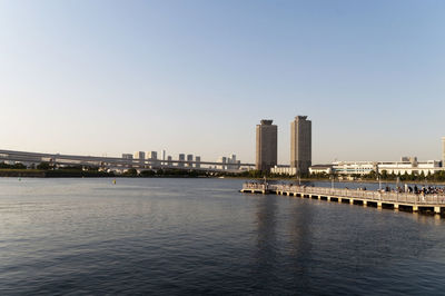 Buildings in city against clear sky