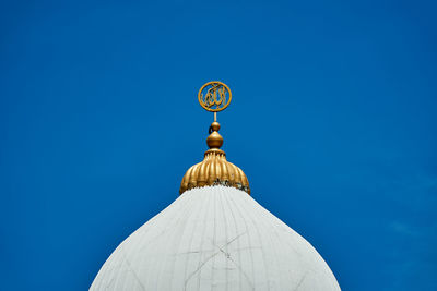 Low angle view of dome against building against clear blue sky