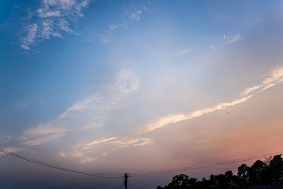 Low angle view of silhouette trees against sky at sunset