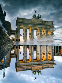 Reflection of building in puddle