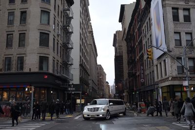 Vehicles on road along buildings