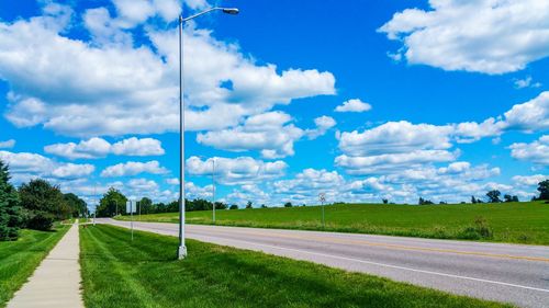 View of golf course against blue sky