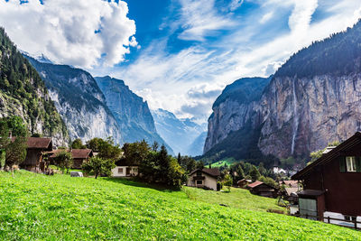 Houses by mountains against sky