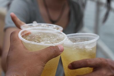 Friends toasting drinking glasses outdoors