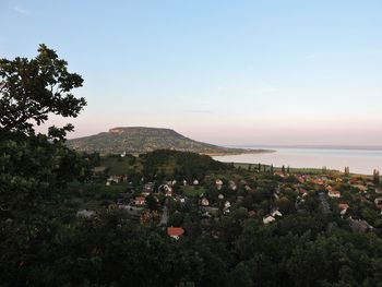 High angle view of townscape by sea against sky