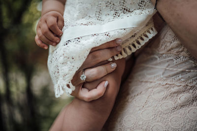 Midsection of woman holding hands