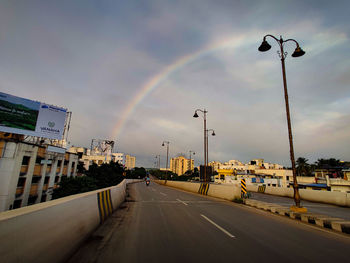 View of rainbow over city street