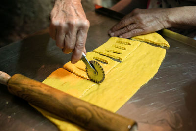 Midsection of person preparing food on table