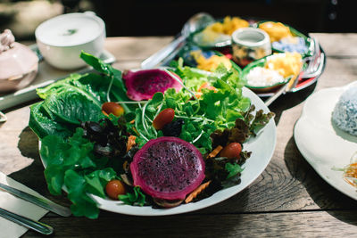 High angle view of chopped fruits in plate on table