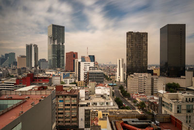 High angle view of buildings in city against sky
