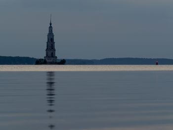 Mid distance view of kalyazin bell tower in volga river at dusk