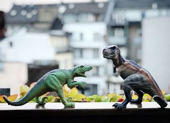 Close-up of figurines on railing