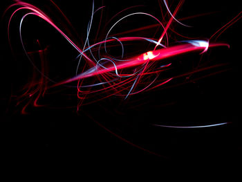 Close-up of light painting against sky at night