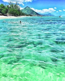 Scenic view of sea against blue sky