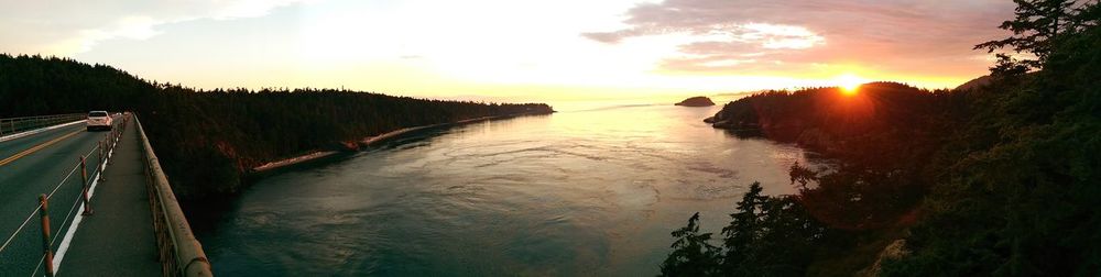 Scenic view of river at sunset