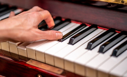 Midsection of man playing piano