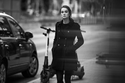 Portrait of woman standing in car