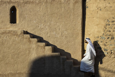 Rear view of woman walking on staircase