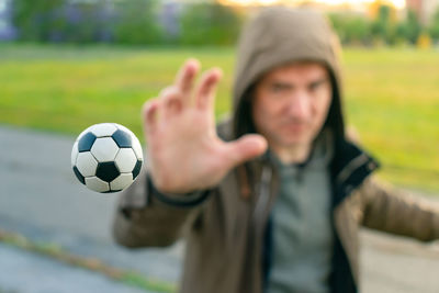 The soccer ball flies in the air into the hands of the goalkeeper