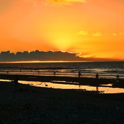 Scenic view of sea against orange sky