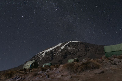 Low angle view of mountain against star field at night