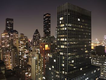 Illuminated cityscape against clear sky at night