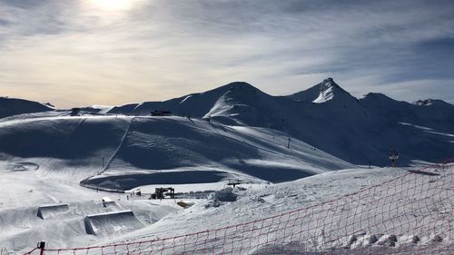 Scenic view of snow covered mountains against sky