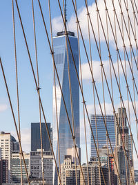 Low angle view of suspension bridge against sky
