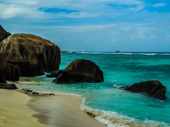 Rocks in sea against sky