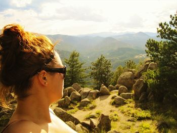 Side view of woman against mountains