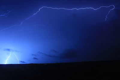 Low angle view of lightning in sky at night