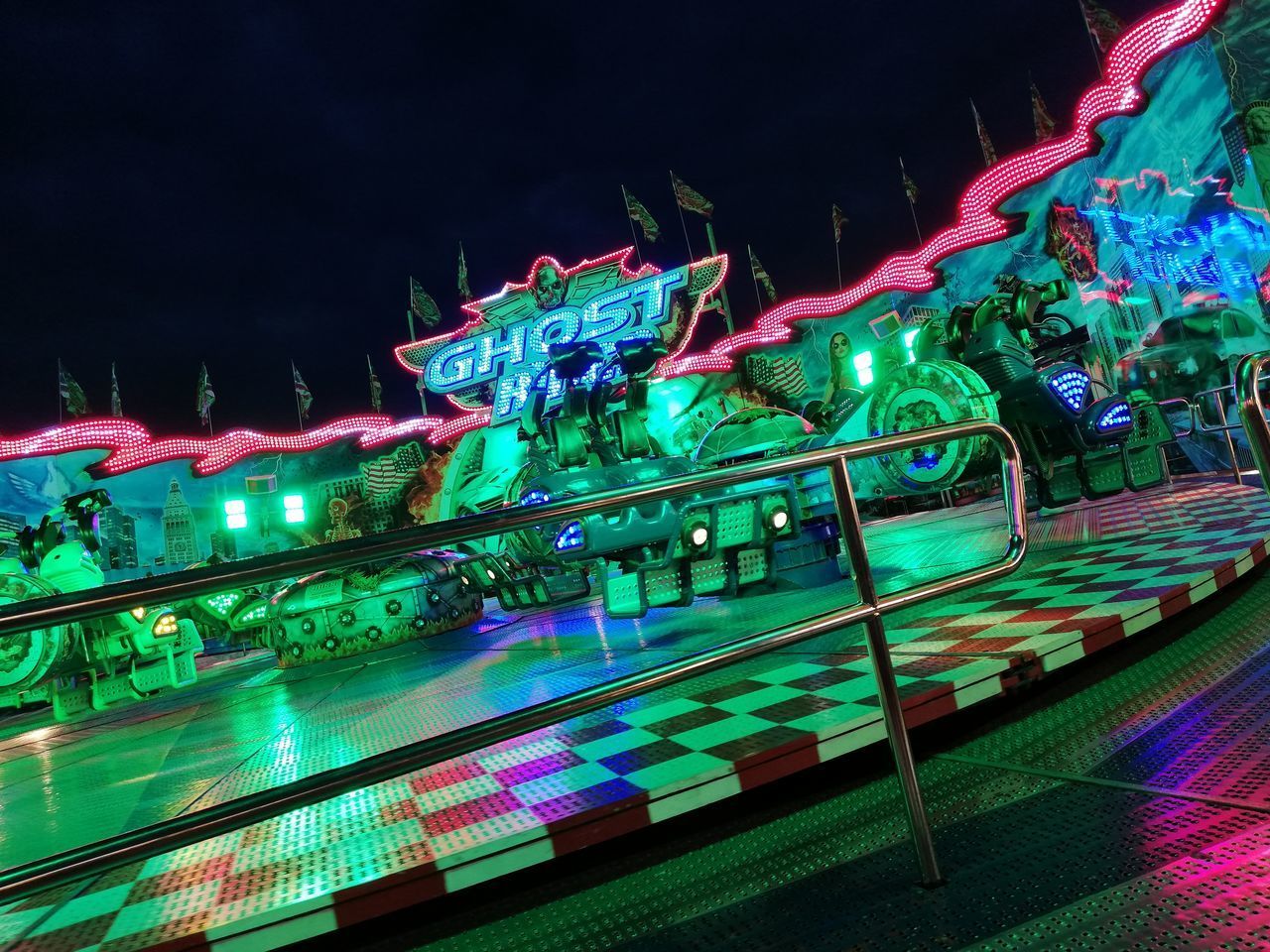 HIGH ANGLE VIEW OF ILLUMINATED CAROUSEL IN PARK