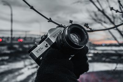 Close-up of camera photographing against sky