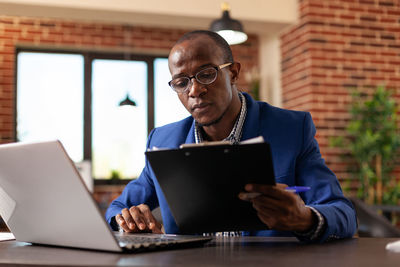 Young man using laptop at office