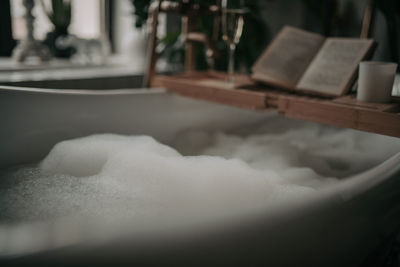 Luxury interior of big bathroom at modern african style with oval bathtub in natural lighting