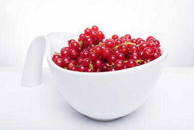 Close-up of strawberries in bowl against white background