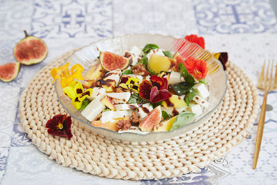 Autumn dinner recipe - vegetarian salad with mango, feta, edible flowers, figs, peach, basil 