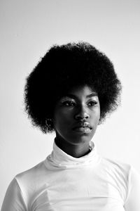 Portrait of beautiful young woman against white background