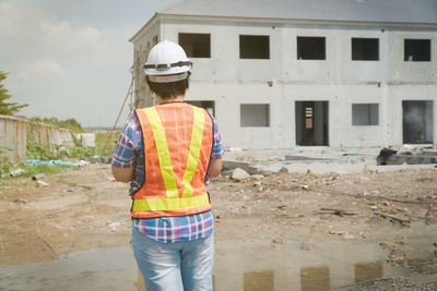 Rear view of man working at construction site