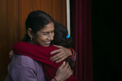 Young woman smiling at home