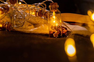 Close-up of illuminated glass jar on table