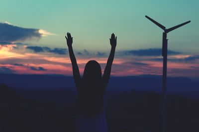 Silhouette person against sky during sunset
