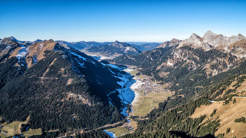 High angle view of mountains against clear blue sky