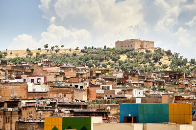 Buildings in town against sky