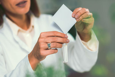 Close-up of woman holding test tube