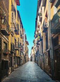 Narrow street amidst buildings against sky